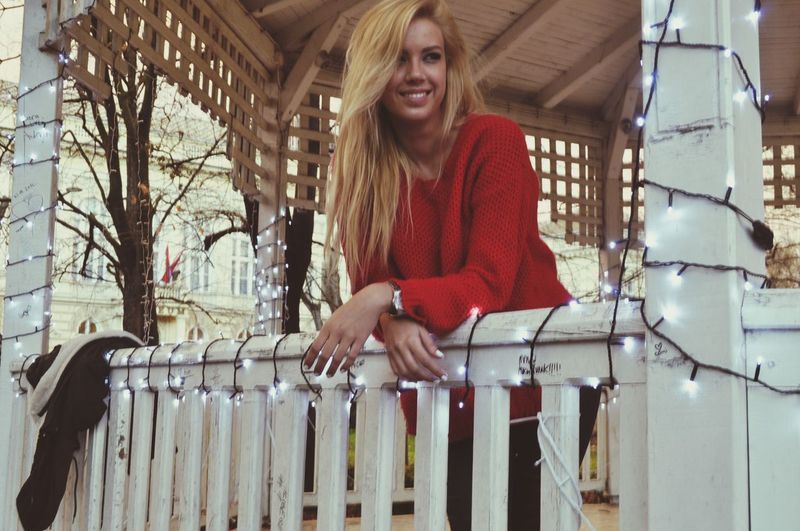 Smiling young woman standing on floor