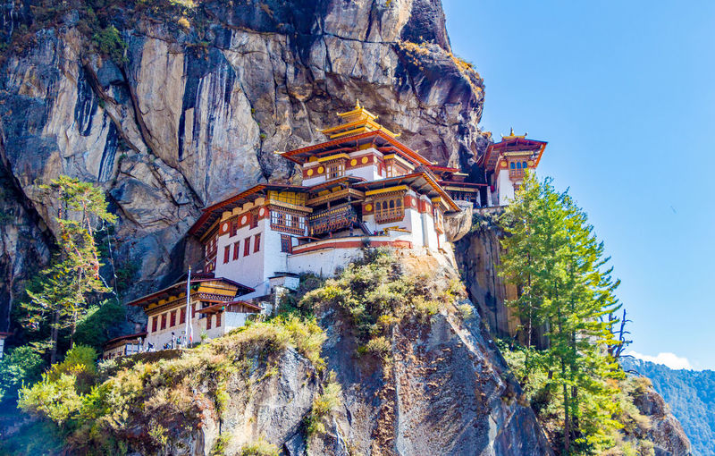 Buddhist temples on cliff against mountains