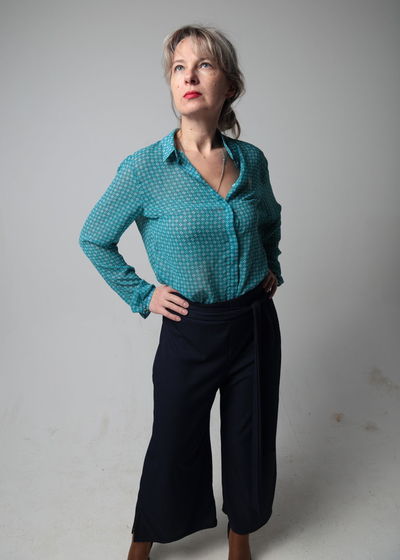 Portrait of woman standing against white background