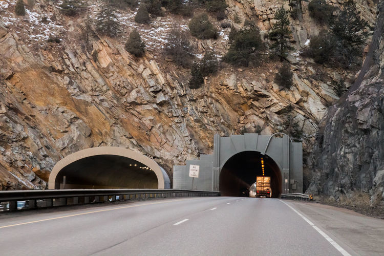 Truck in tunnel against mountain