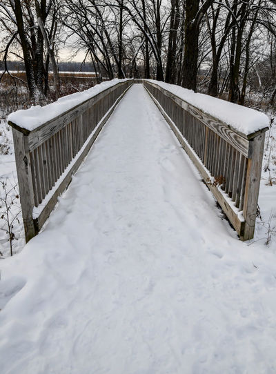 Bridge over snow covered landscape