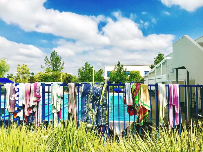 Multi colored clothes drying on clothesline against sky