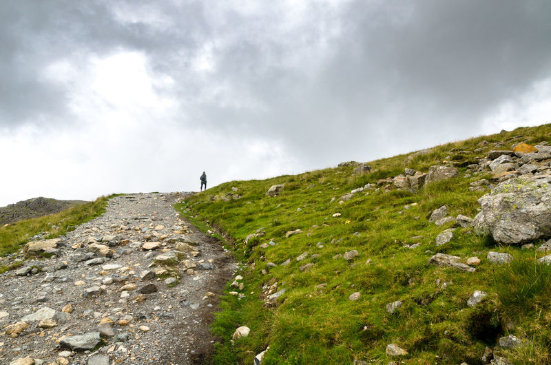Hiking a rocky path at scafell pike, englands tallest mountain 