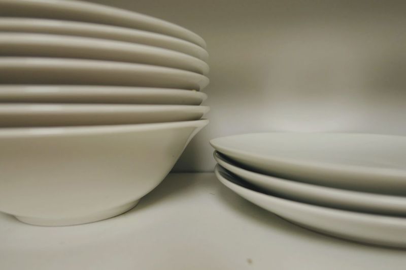 Close-up of empty plates and bowls on table