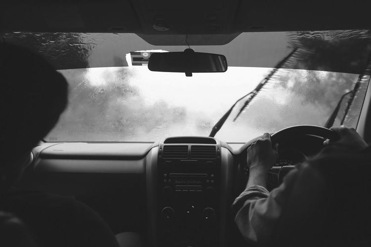 Cropped image of people traveling in car during monsoon