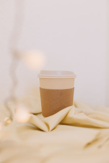 Close-up of drink on bed at home