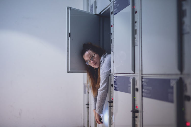 Portrait of young woman relaxing in locker
