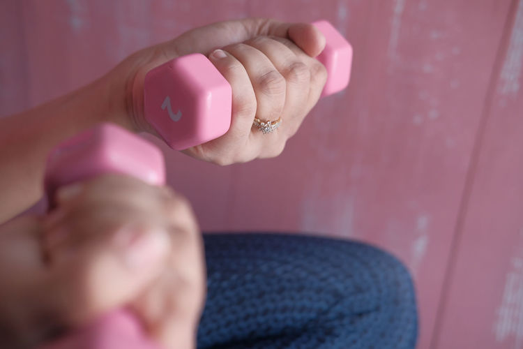 Close up of women hand holding dumbbell