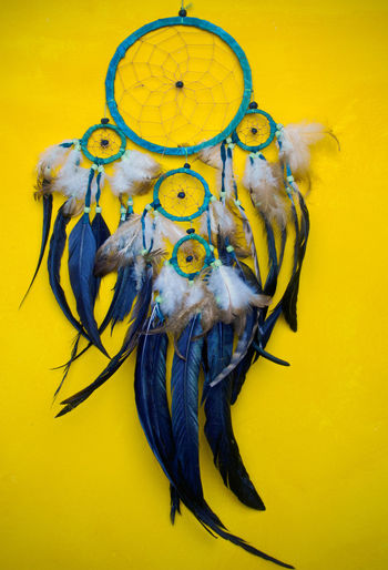 Close-up of dreamcatcher hanging on wall