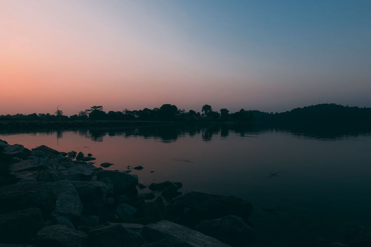Scenic view of lake against sky during sunset