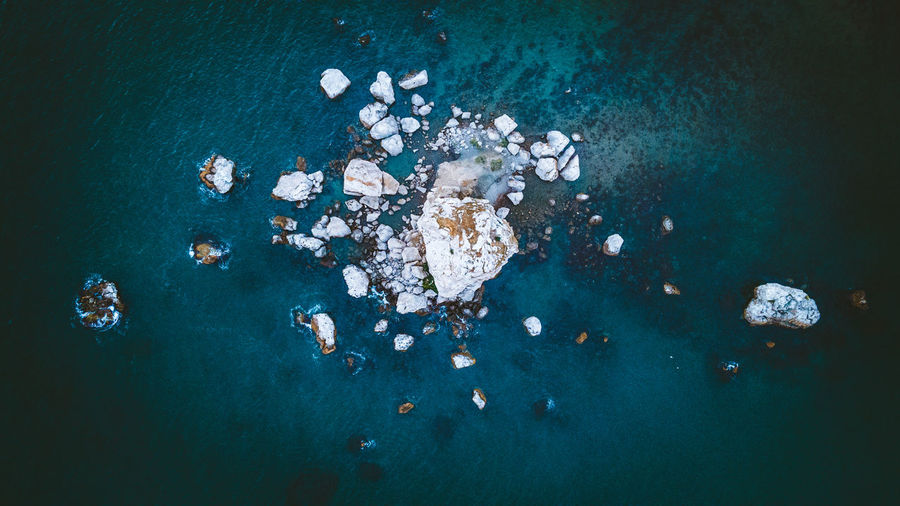 High angle view of rocks in sea