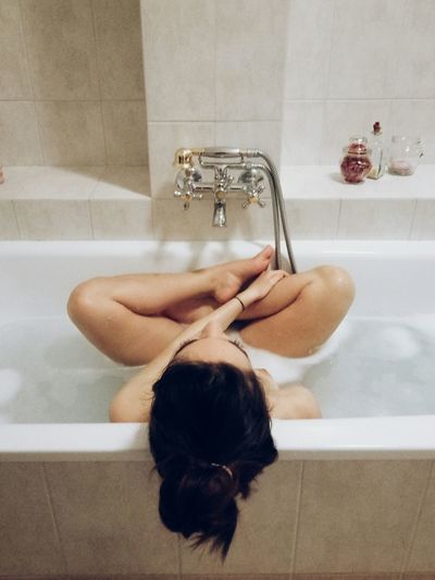 Directly above shot of young woman in bathtub