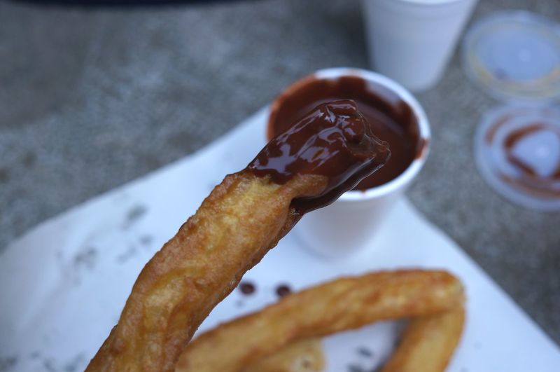 Close-up of churros in chocolate sauce