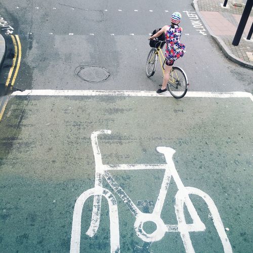 High angle view of woman riding bicycle on street