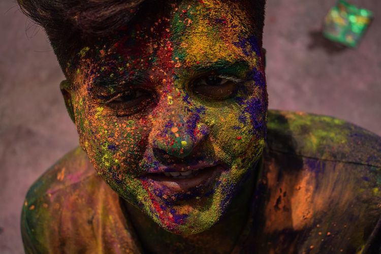 Close-up portrait of man with powder paint on face