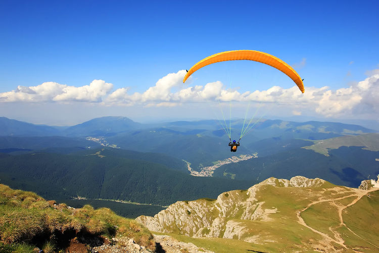 One person flying with yellow paraglider