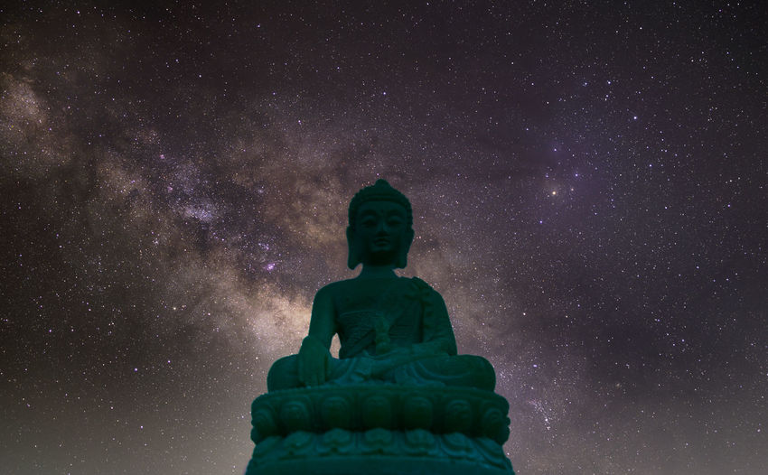 Low angle view of statue against sky at night