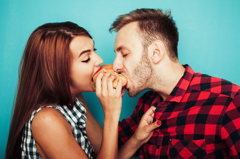 Young couple eating burger