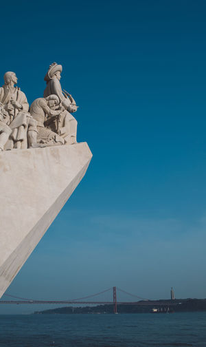 Statue of sea against blue sky
