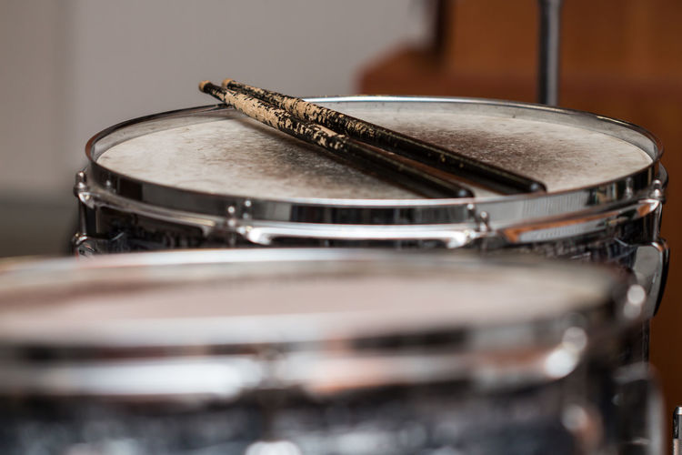 Close-up of drumsticks on drum