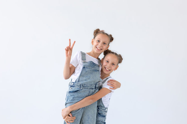 Portrait of happy friends against white background