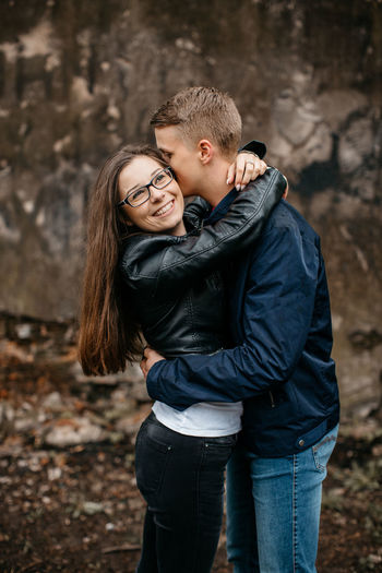 Young couple embracing while standing on street