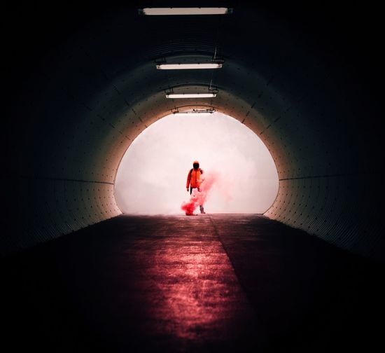 Silhouette man in tunnel