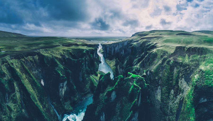 Scenic view of river amidst mountains