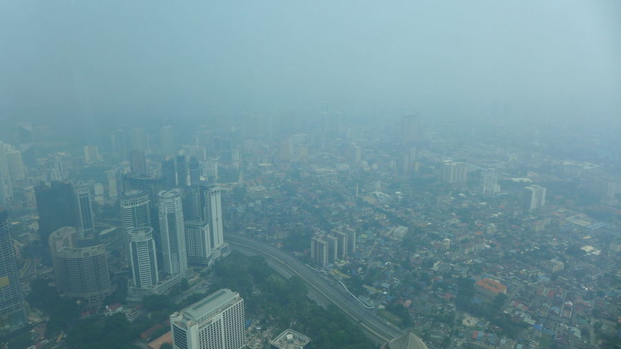Aerial view of city buildings during foggy weather
