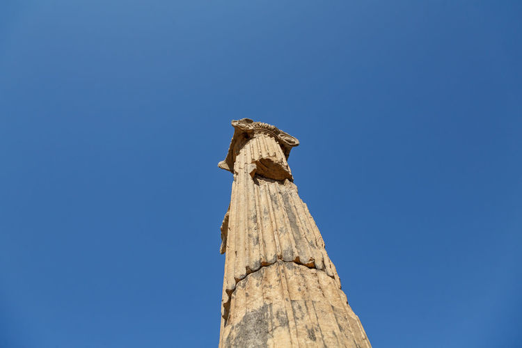  low angle view of roman column against a clear blue sky