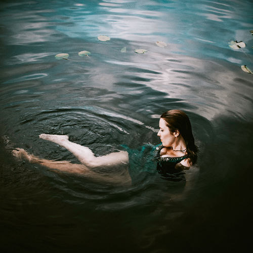 High angle view of woman swimming in lake