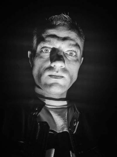 Portrait of man in darkroom