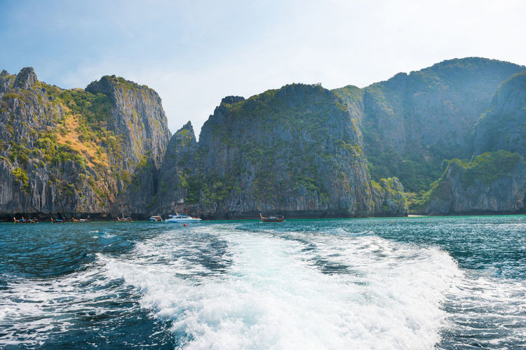 Panorama of famous phi phi island in thailand with waves boat, sea and mountains in beautiful lagoon
