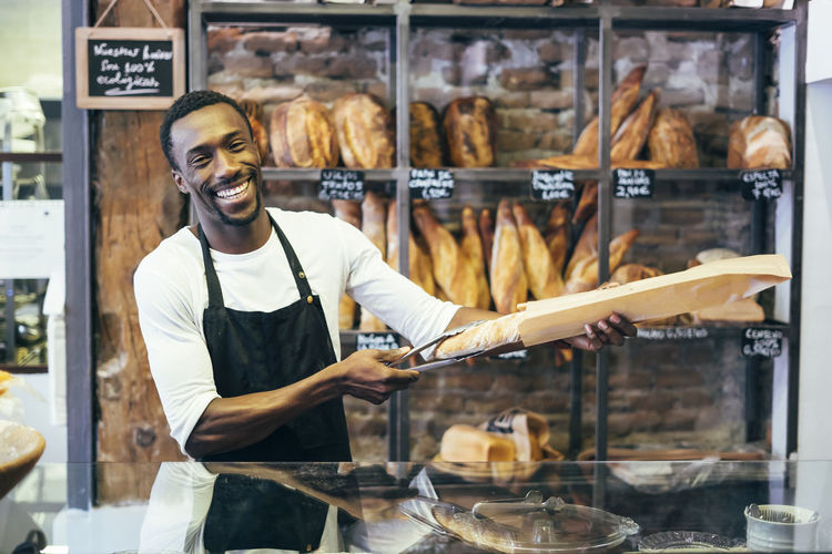 African man working in bread pastry.