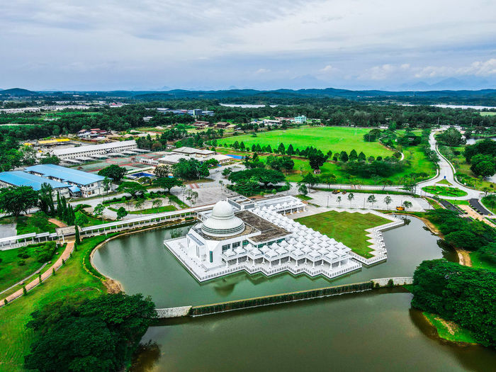 High angle view of river amidst buildings against sky