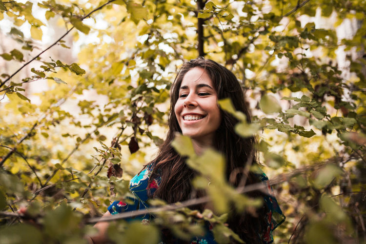 Woman standing on land in forest