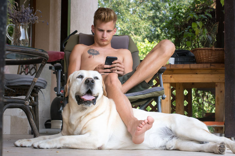 Portrait of man with dog sitting outdoors