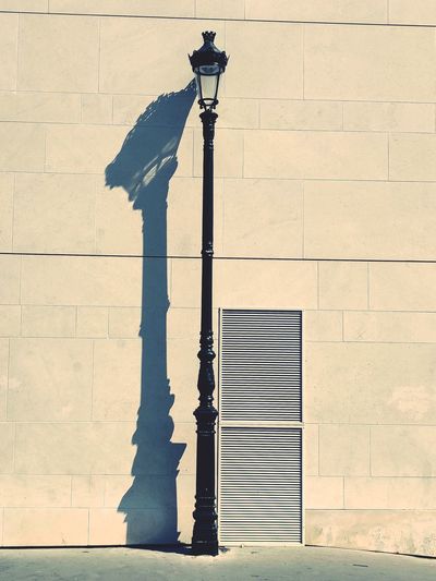 Street light against building in city