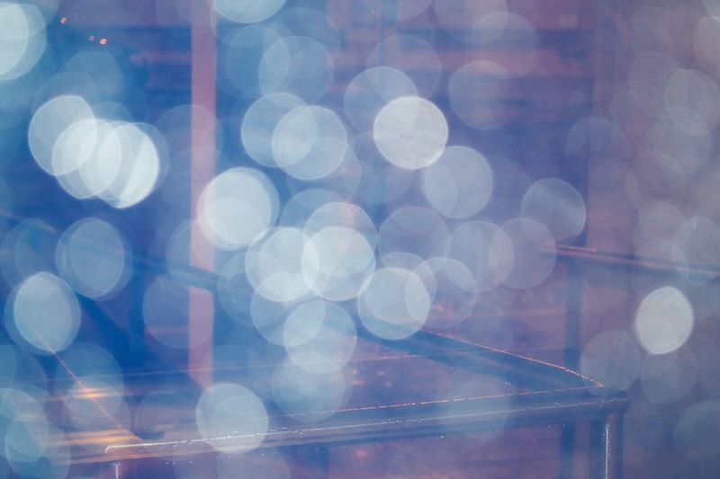Defocused image of mobile phone against sky