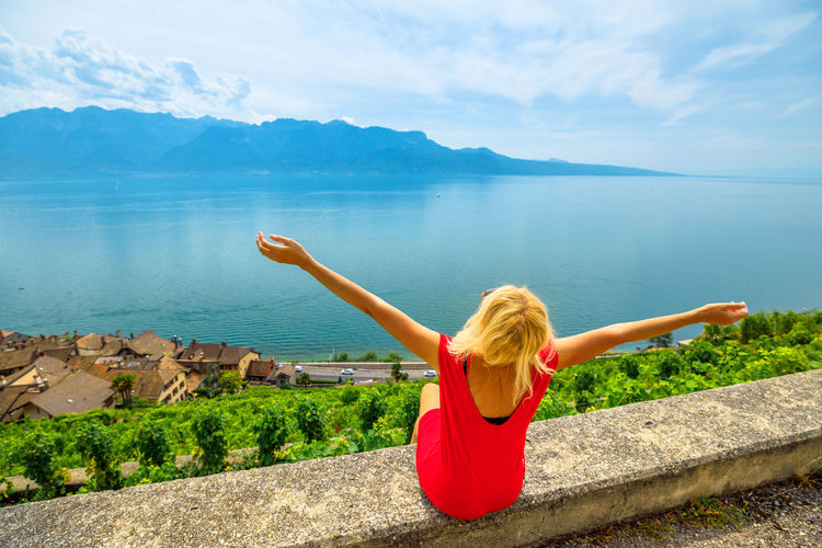 Rear view of woman looking at sea against sky