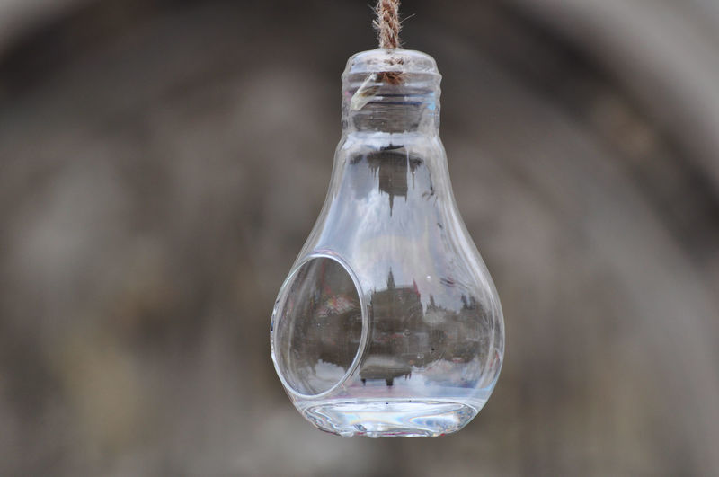 Close-up of light bulb hanging in water