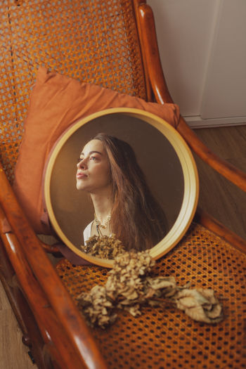Woman looking away reflecting in mirror