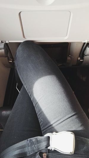 Midsection of person sitting in airplane