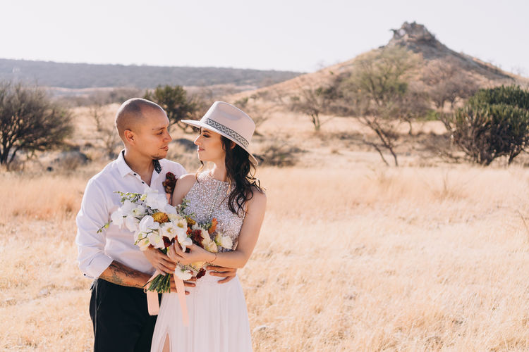 Side view of couple kissing on wedding day 