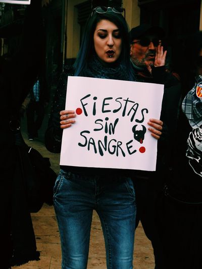 Woman holding placard during poster