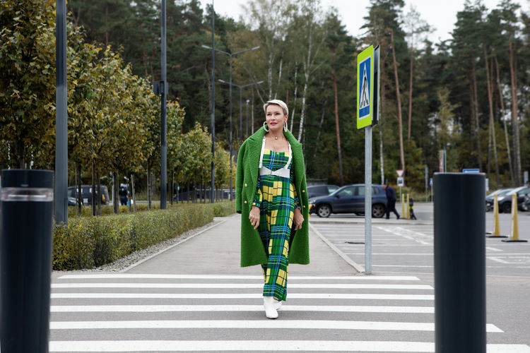 Stylish woman in wool green coat. style and fashion. street fashion trend. fashionable model walks 