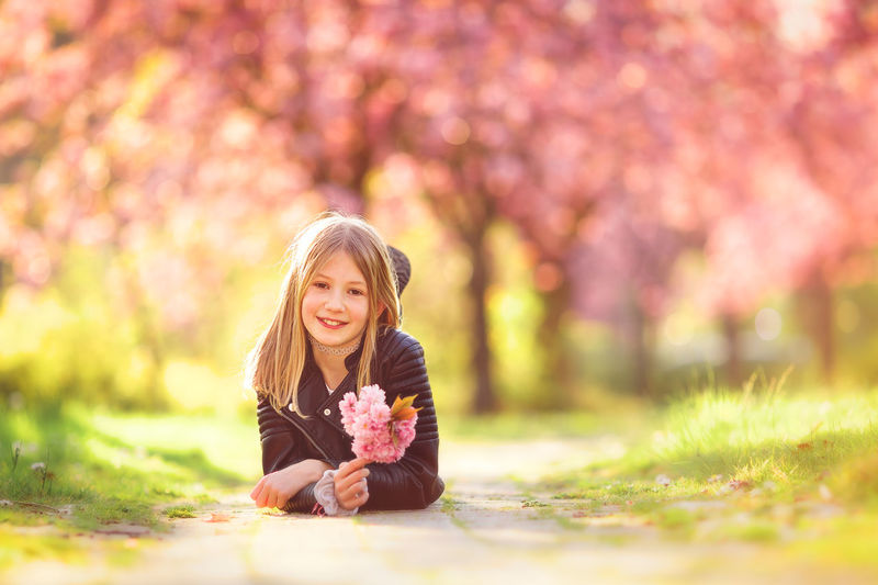 Portrait of happy girl with pink flower