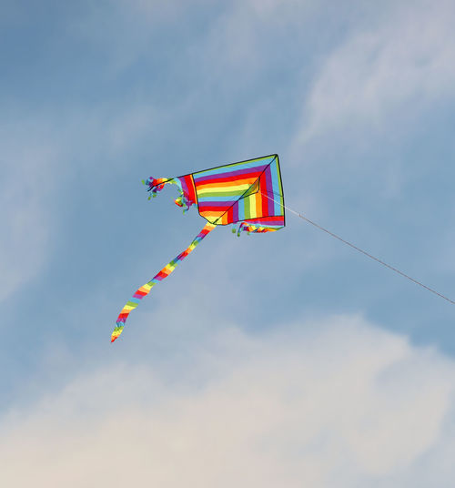 Low angle view of kite flying against sky