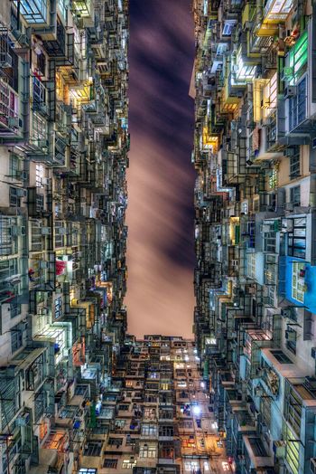 Directly below shot of montane mansiona against sky at quarry bay in city during night