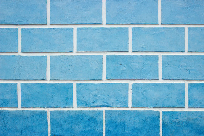 Textures on the blue wall, blue brick wall background.
